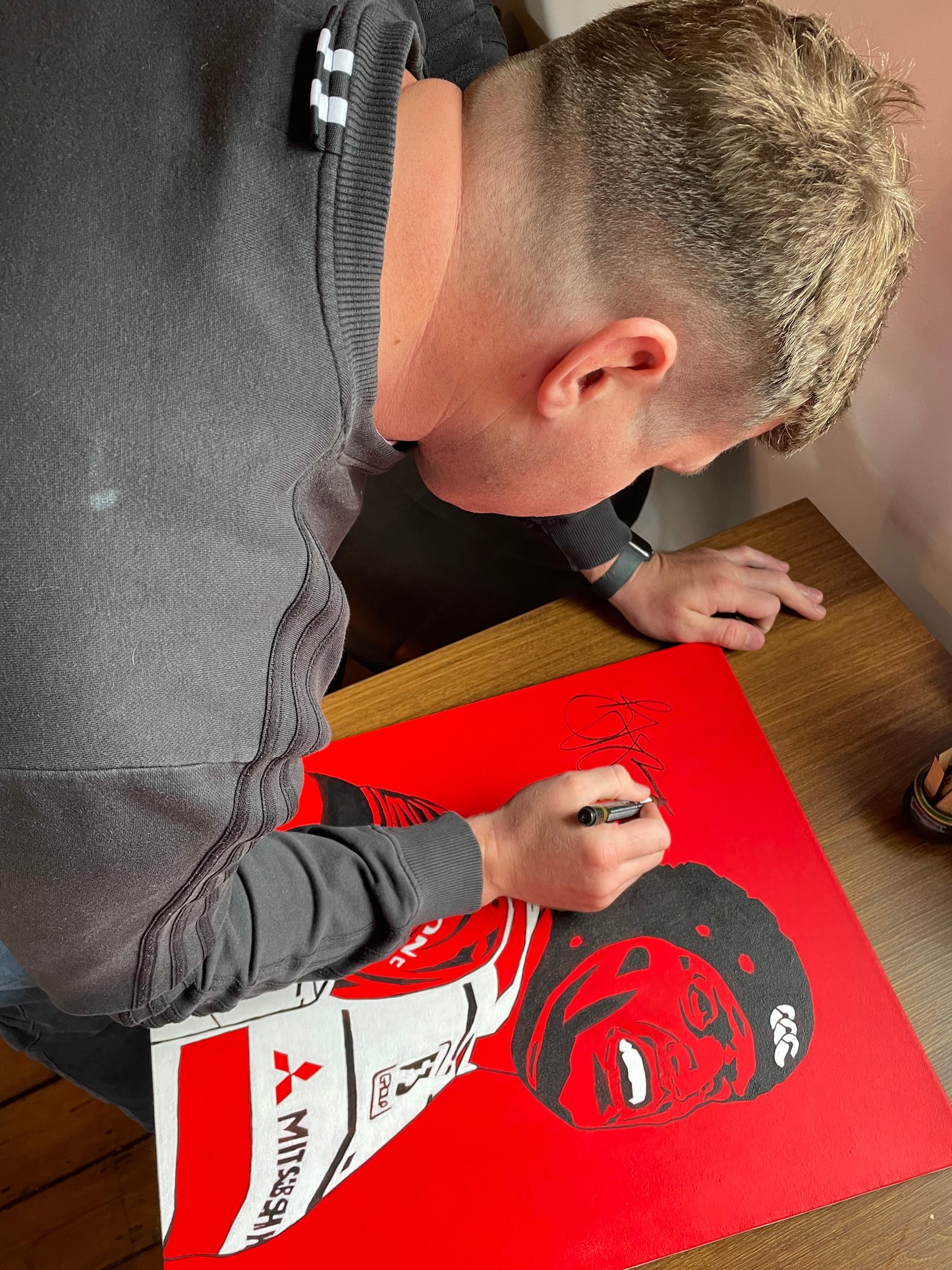 Ben Morgan signing the original canvas painting